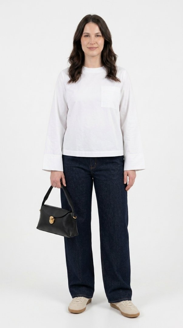 Woman in a cream linen co-ord set with a straw bag