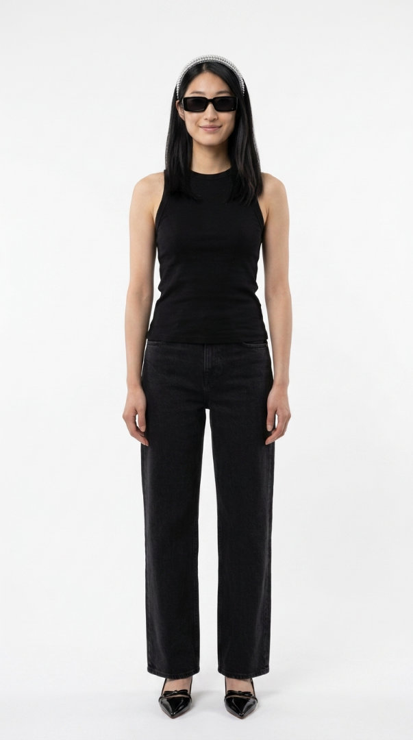 Woman in a knit vest with wide trousers and loafers