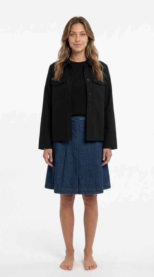 Woman in a black slip dress with a leather jacket