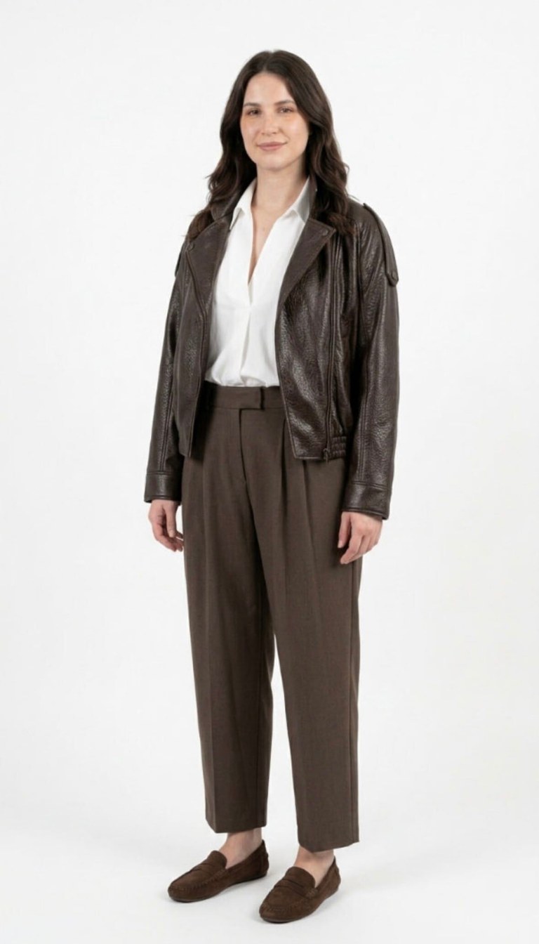 AI digital twin wearing a brown leather jacket over a white blouse with dark tailored trousers
